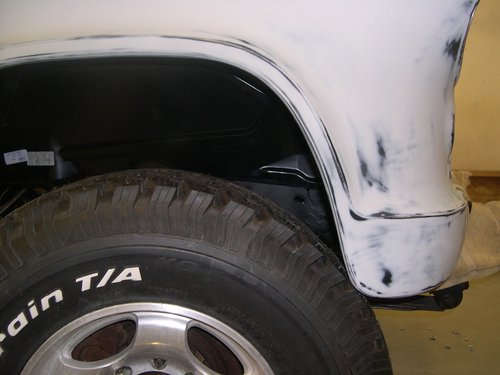 During pre-paint assembly see how the tire size interfered with the lower front fender. The next pictures show how this was fixed.