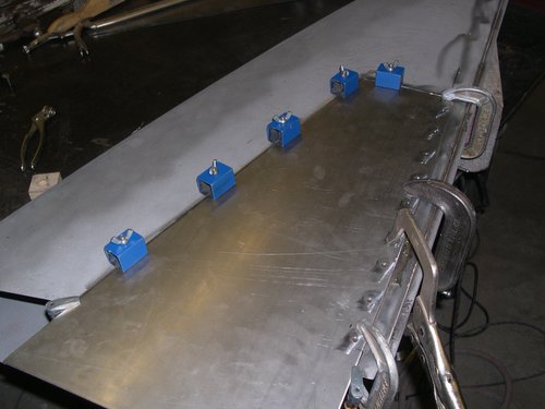 Damaged left hood side gets new metal after shaping on the english wheel.