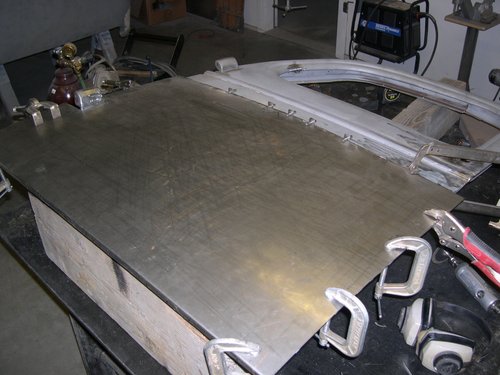 We used english wheel to shape new door skins. This is getting everything positioned for welding and rolling edges around door frame.