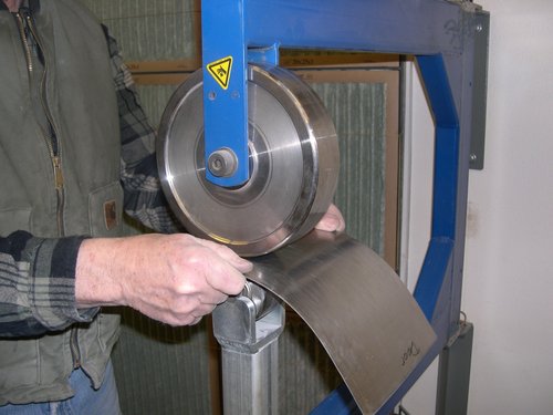 Rolling out the new lower rear cab corner patch panel on the english wheel.