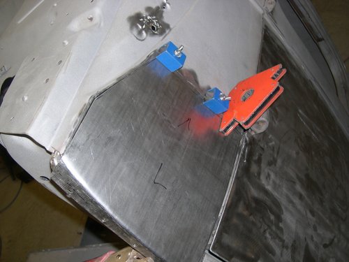 New outer lower cowl patch panel in position after fabrication on english wheel, brake and shrinker/stretcher.